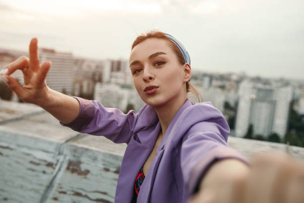 istock Trendy lady taking selfie on rooftop 1250032127
