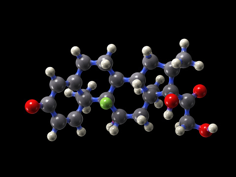 A molecular model of the drug dexamethasone. One of the first drugs proven to cut the risk of death from COVID-19. It is a cheap steroid drug used in many treatments.\nIsolated on black.