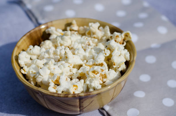istock Popcorn in a brown bowl closeup side view 1250034054