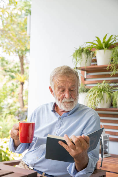 istock Senior retirement man happy reading book at home 1250035094