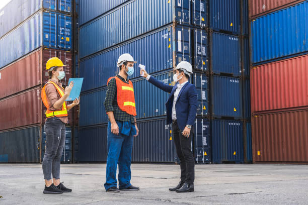 istock Engineer worker wearing surgical mask checking body temperature using infrared digital thermometer check temperature before into workplace, workers with a protective mask 1250035508