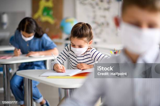 Children With Face Mask Back At School After Covid19 Quarantine And Lockdown Stock Photo - Download Image Now