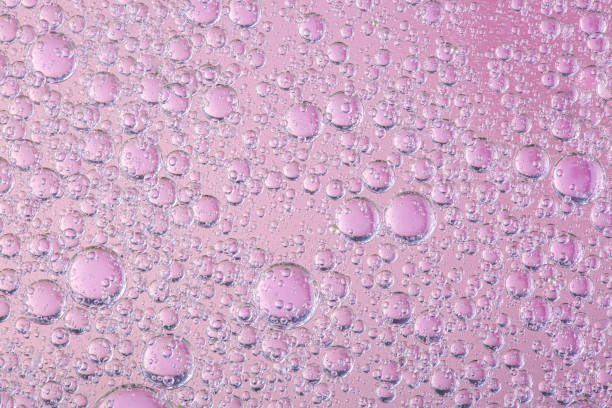 istock oil with bubbles on coral background. Pink Abstract space background. Soft selective focus. macro of oil drops on water surface. copy space. air bubbles in water 1250039899