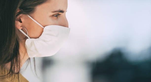 istock close up. a young woman in a protective mask 1250041247