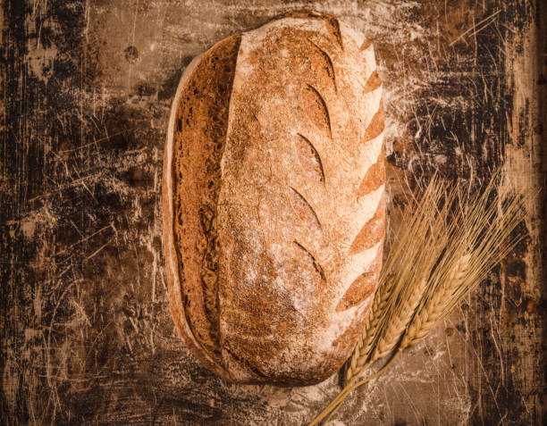 istock Bakery gold rustic crusty loaf of bread on rustic background. 1250041307