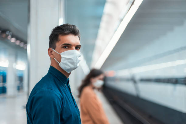 istock passengers in protective masks standing at a metro station at a safe distance 1250041380
