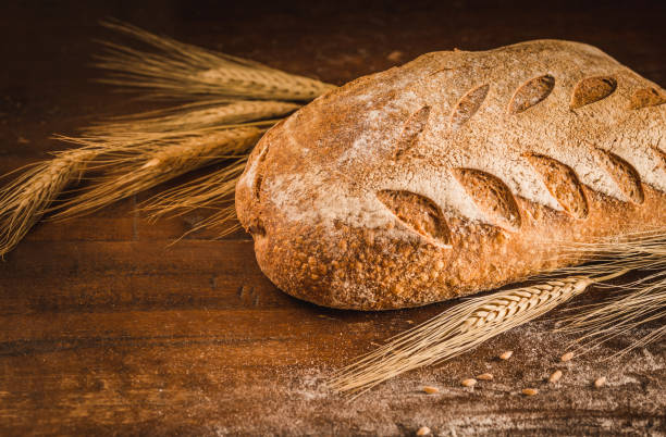 istock Bakery gold rustic crusty loaf of bread on rustic wood background. 1250041398