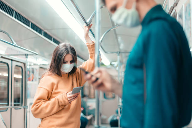istock people with smartphones standing in a subway car 1250041411