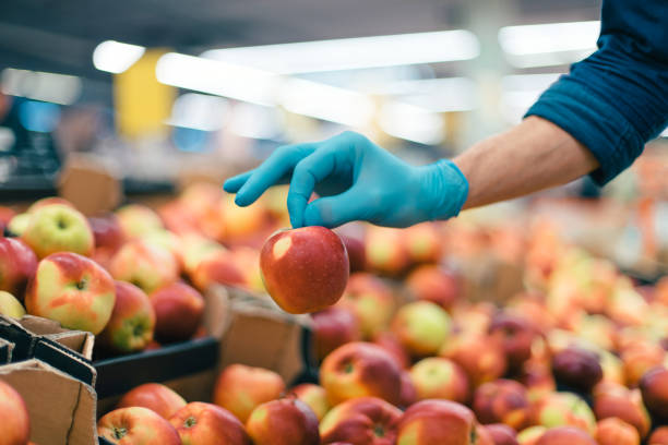 istock background image of a man in protective gloves picking apples 1250041462