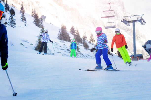 istock Alpine ski class group of kids together on slope 1250045254