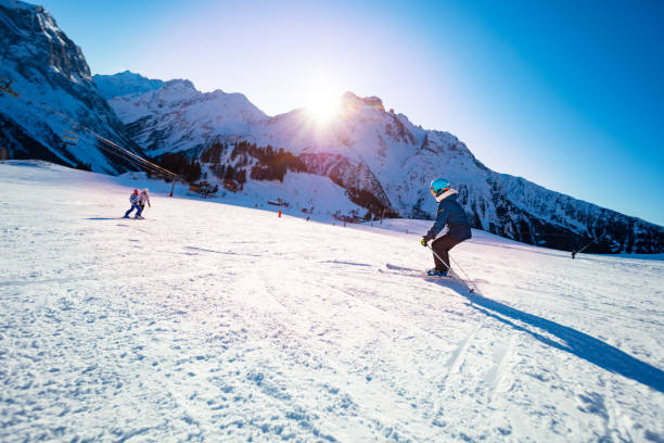 istock Girls ski downhill mountain together before sunset 1250045261