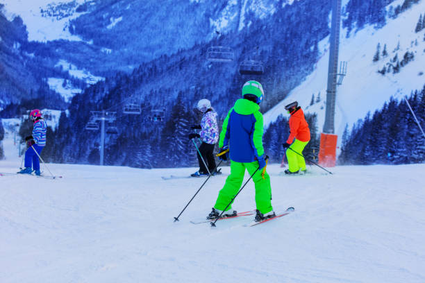 istock Boy with a group of kids ski downhill together 1250045281