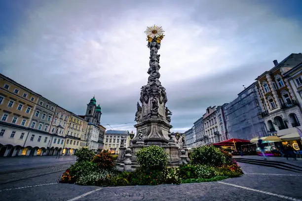 Beautiful ancient Trinity Column with architecture around in Linz, Austria