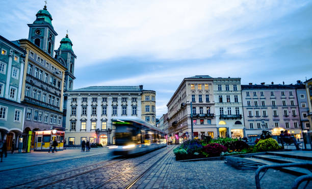 Tramway with architecture around in center of Linz, Austria Riding tramway with beautiful architecture around in center of Linz, Austria linz austria stock pictures, royalty-free photos & images