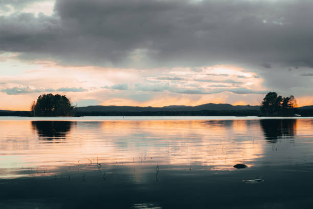 istock Two islets in a lake with dramatic sky in the background in Sweden 1250048157