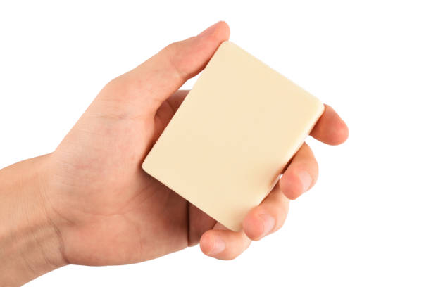 Man hand holding a natural soap bar (Clipping path) on the white background