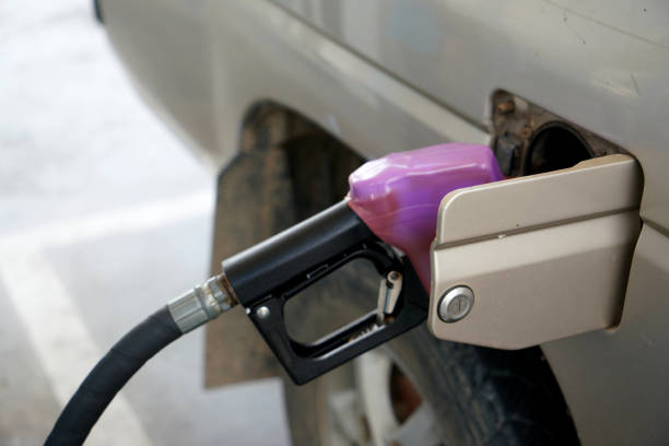 Car being refueled at a rural gas station at sunset