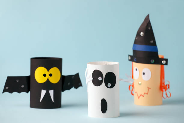 istock Halloween toy collection ghost, bat, witch on blue for Halloween concept background. Paper crafts, DIY. Handcraft creative idea from toilet tube, recycle concept 1250053496