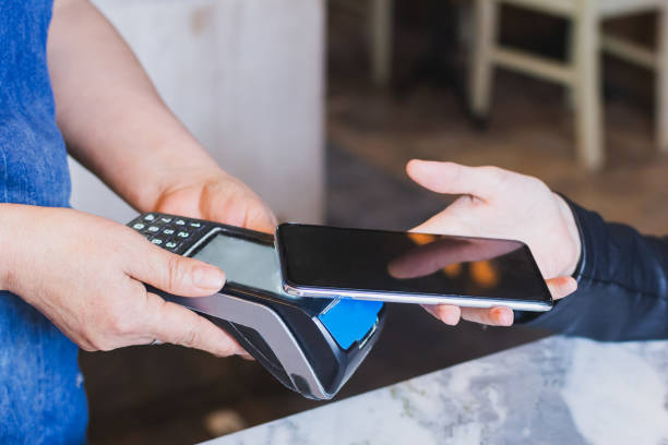 istock paying with the smartphone in the cafeteria 1250054051