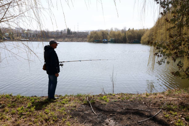 istock Senior man fishing on lake 1250054101