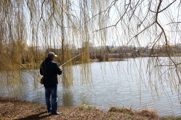istock Man fishing on lake in spring 1250054104