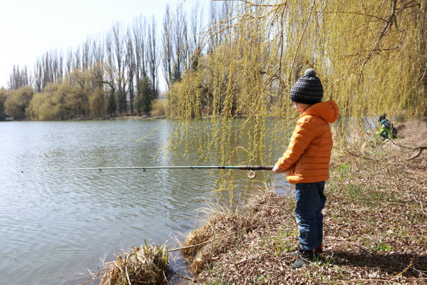 istock Child fishing on lake in spring 1250054112