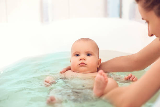 istock Hands of a careful unknown mother hold boy 1250055267
