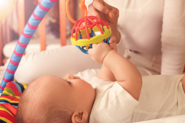 Sister playing with your younger brother Toddler plays with his sisters. The concept of development of babies and care. slow motion face stock pictures, royalty-free photos & images