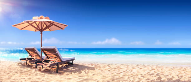 Two Chairs And Parasol With In The Golden Beach Two Luxury Chairs And Umbrella With In The Golden Beach french overseas territory stock pictures, royalty-free photos & images