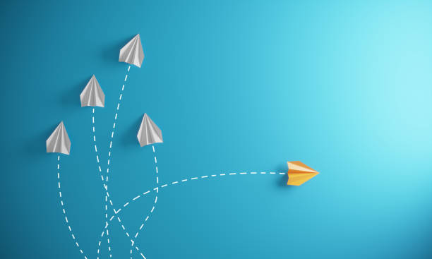 Different Approach - Different Direction Group of paper airplane in one direction and with one individual pointing in the different way, can be used leadership/individuality concepts.( 3d render ) standing out from the crowd stock pictures, royalty-free photos & images
