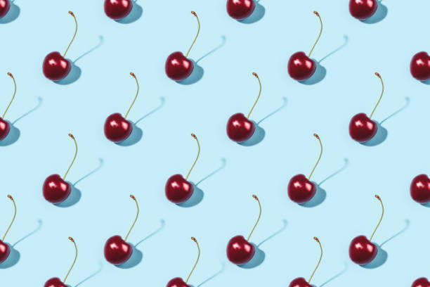 istock Bright pattern of ripe cherries on a blue background. 1250060633
