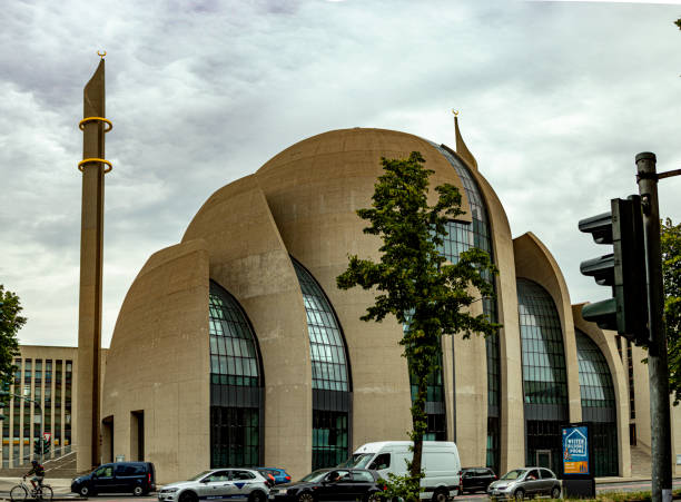 Mosque of Muslim. Crescent on copper covered dome and minaret of mosque against blue sky. Symbol of Islam and Ramadan.