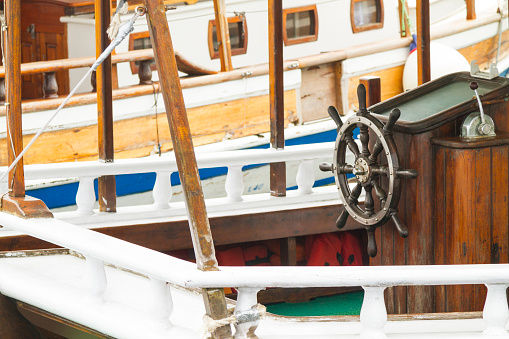 Cartagena, Murcia - Spain - 01-16-2024: Close-up of classic sailing ship's wooden side and rigged ropes in Cartagena's historical marina