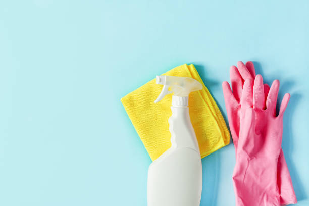 istock Bottle of detergent, microfiber rag and protective gloves on pastel blue background top view. Housework cleaning concept. 1250061043