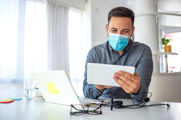 istock Man in a medical mask at the office. 1250063683