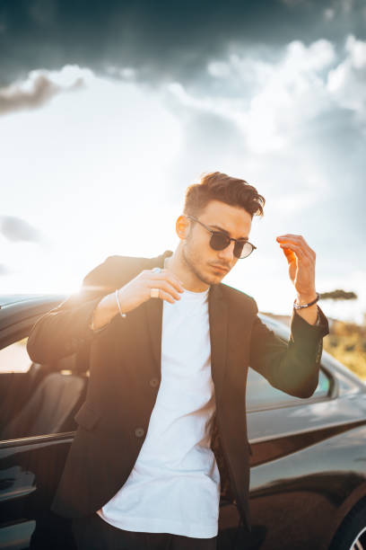istock serious fashion man with a car 1250064449
