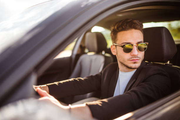 istock handsome fashion man driving 1250065577