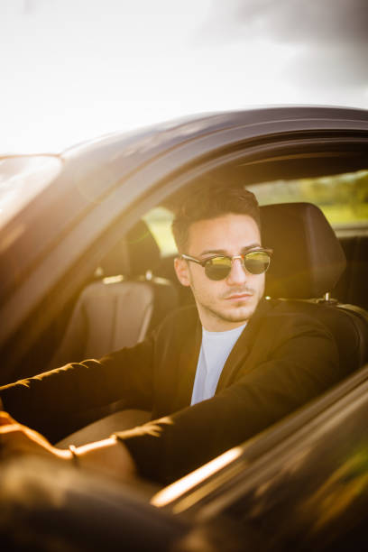 istock handsome fashion man driving 1250065595