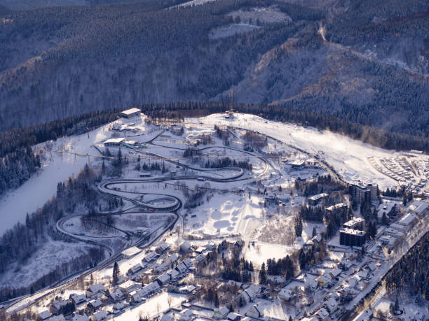 Aerial view of the bobsleigh track in Winterberg Sauerland with snow Railway; landscape; tree; mountain; blue; bobsleigh track; ice; cold; frost; frozen; area; season; nature; road; sauerland; snow; snow-covered; ski; skiing; slope; forest; white; weather; winter; winterberg; winterberg photos stock pictures, royalty-free photos & images
