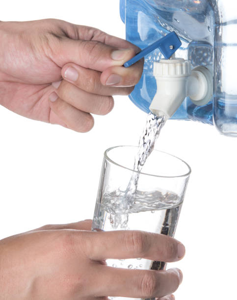 istock Glass filled with drinking water from faucet plastic water container isolated on a white background 1250065684