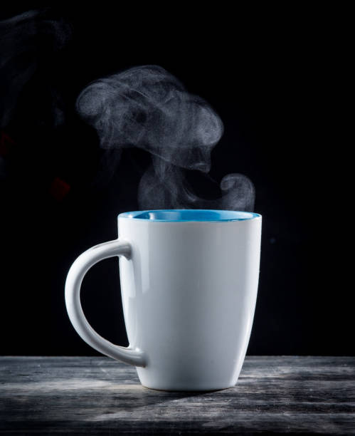 istock Steaming coffee cup with smoke on black background 1250065710