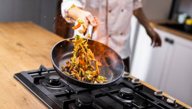 istock Professional Chef Tossing Food 1250066003