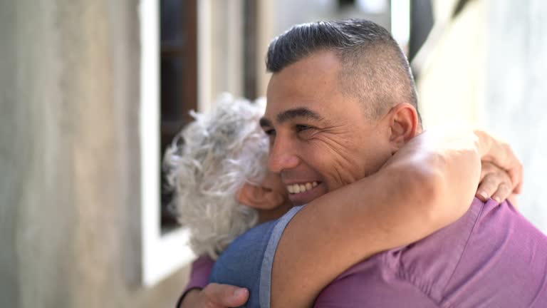 Mother and son embracing at home