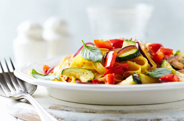istock Pappardelle Pasta with Vegetables and fresh Basil on bright wooden Background. 1250067146