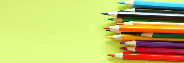 istock Colored pencils on a yellow background. Lots of different colored pencils. Colored pencil. Pencils are sharp. Pencils are on the right. Close-up. Copy space. Background. Flat lay. Banner 1250068647