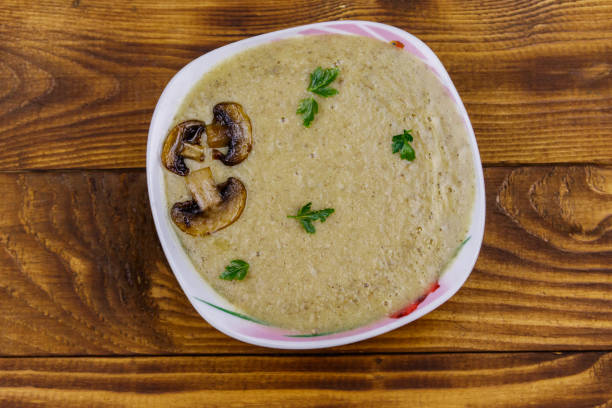 istock Mushroom cream soup on a wooden table. Top view 1250072817