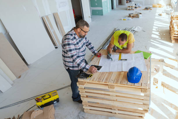 istock Male engeneers workers foreman at a indoors building site with blueprints 1250072850