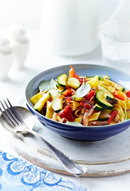 istock Pappardelle Pasta with Vegetables and fresh Basil on bright wooden Background. 1250072867