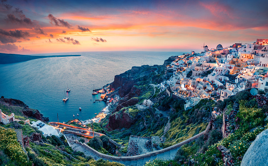 Impressive evening view of Santorini island. Picturesque spring sunset on the famous Greek resort Oia, Greece, Europe. Traveling concept background.