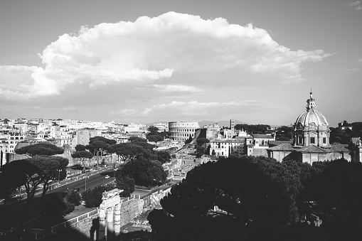 Panoramic view of city Rome with Roman forum and Colosseum from Vittorio Emanuele II Monument also known as the Vittoriano. Summer sunny day and dramatic blue sky
